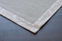 Classic grey linen placemat with flower pattern border.....