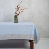 LIGHT BLUE LINEN TABLECLOTH WITH LIGHT BLUE PAISLEY BORDER